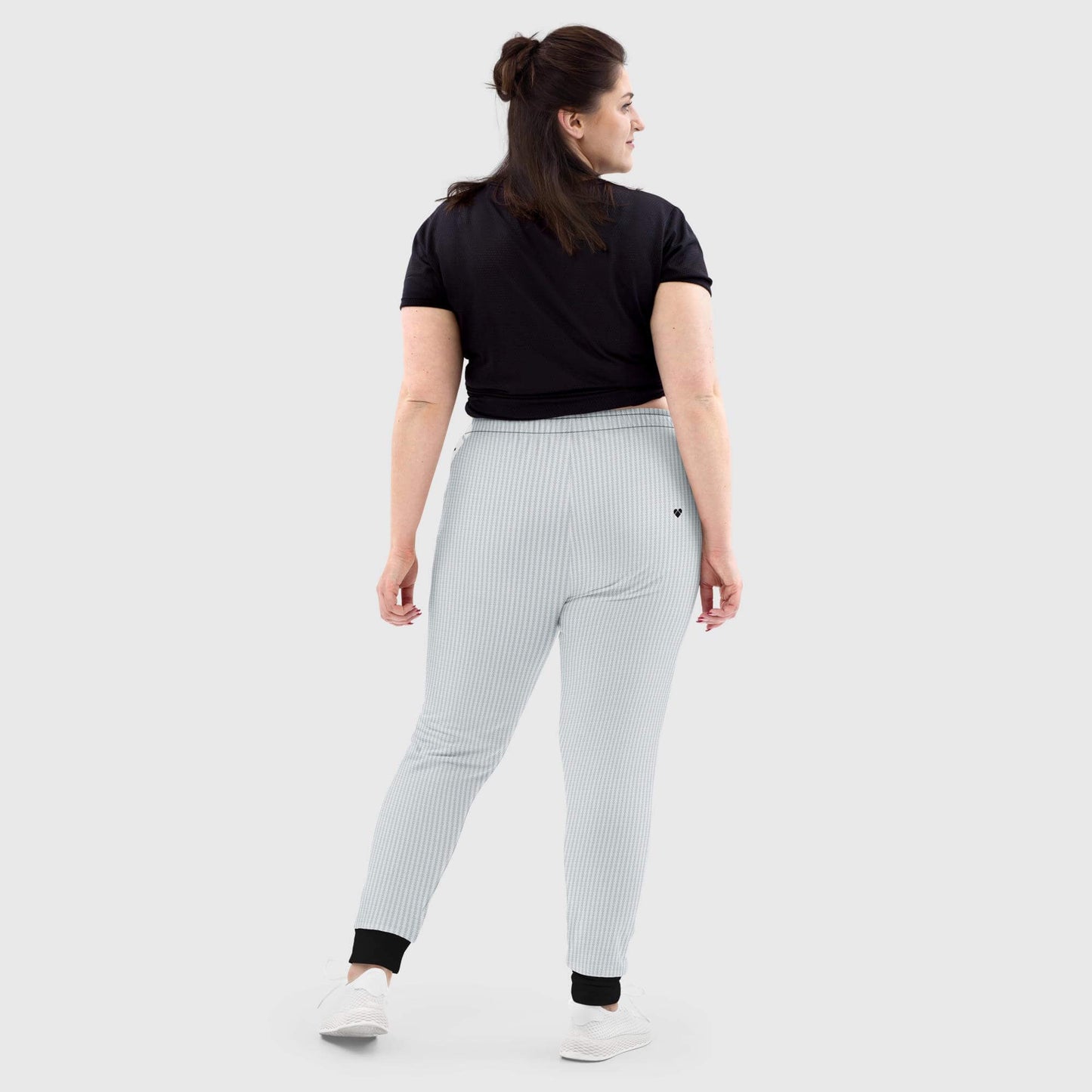 Light gray joggers with black brand hearts stripe