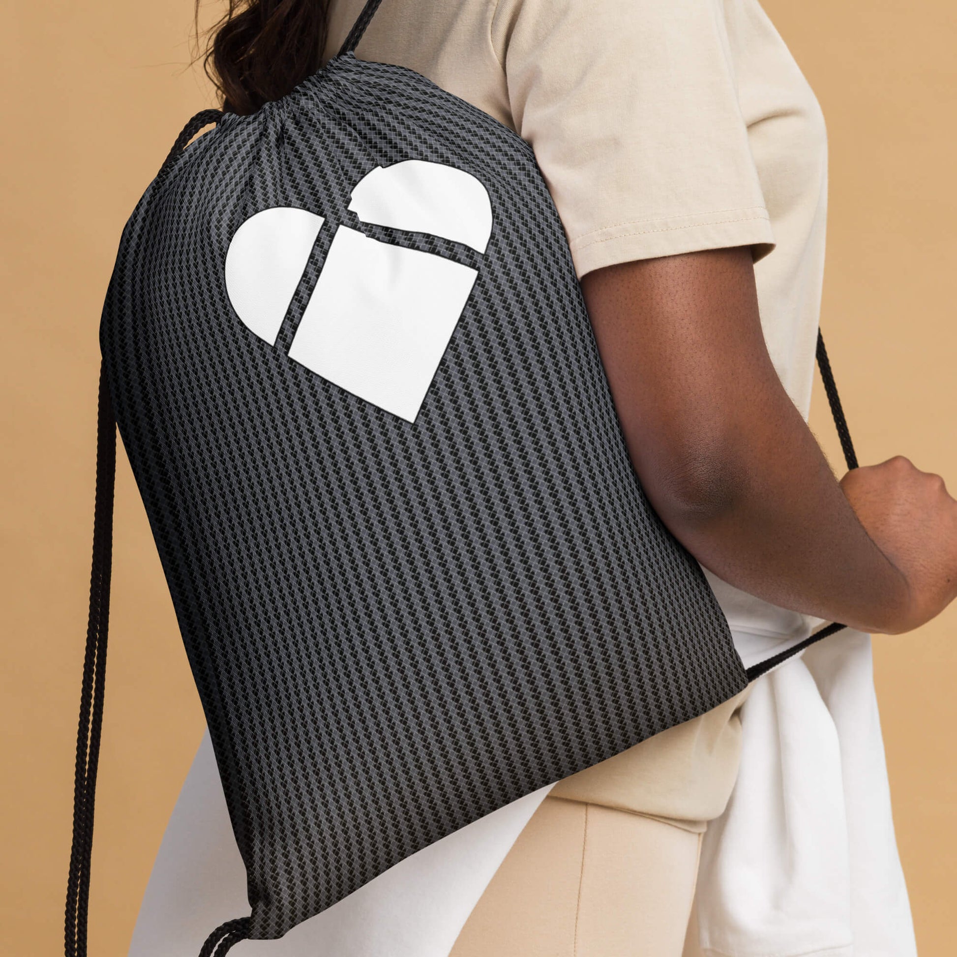 Heart logo and geometric patterns on black drawstring bag 
