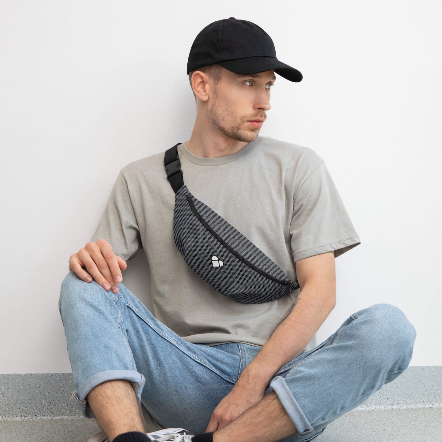 male model wearing Versatile black fanny pack for daily use or sports from Amor Primero Collection