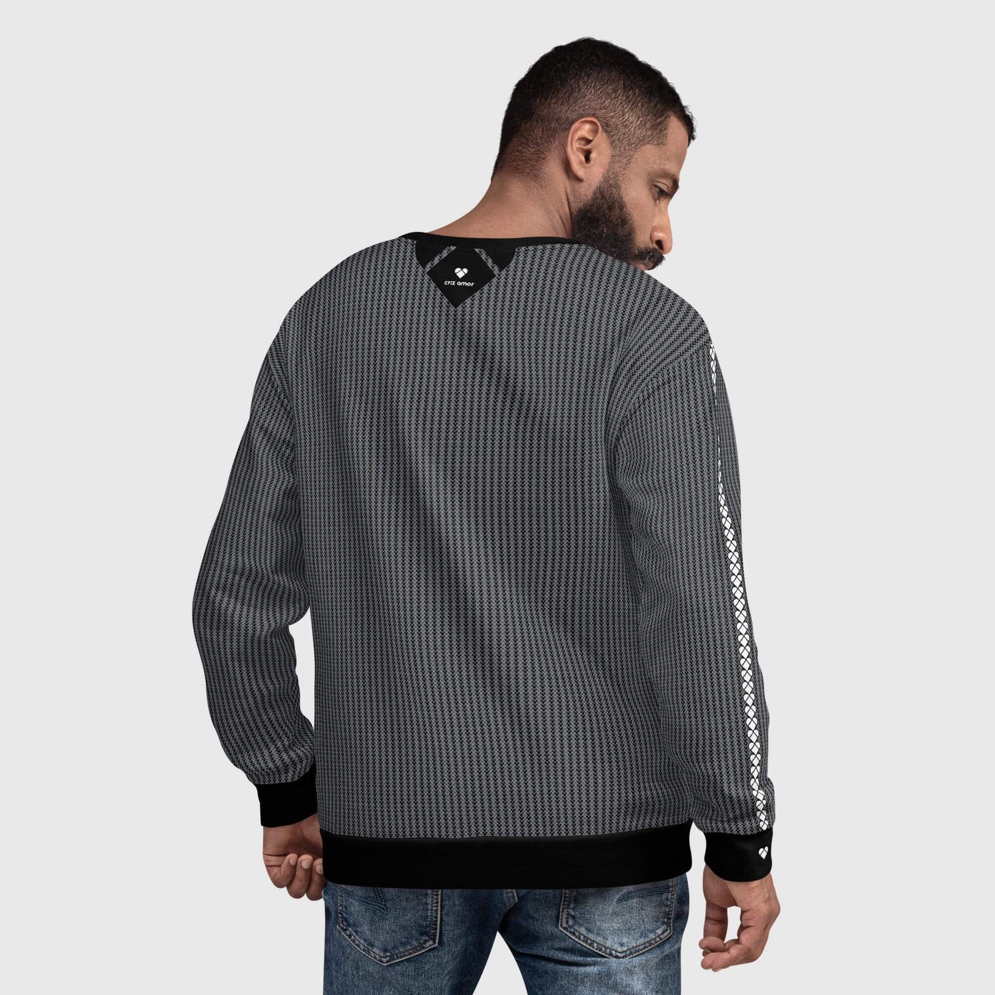 male model wearing a black sweatshirt with a heart-shaped geometrical pattern in two shades of gray by CRiZ AMOR's Amor Primero Capsule Collection