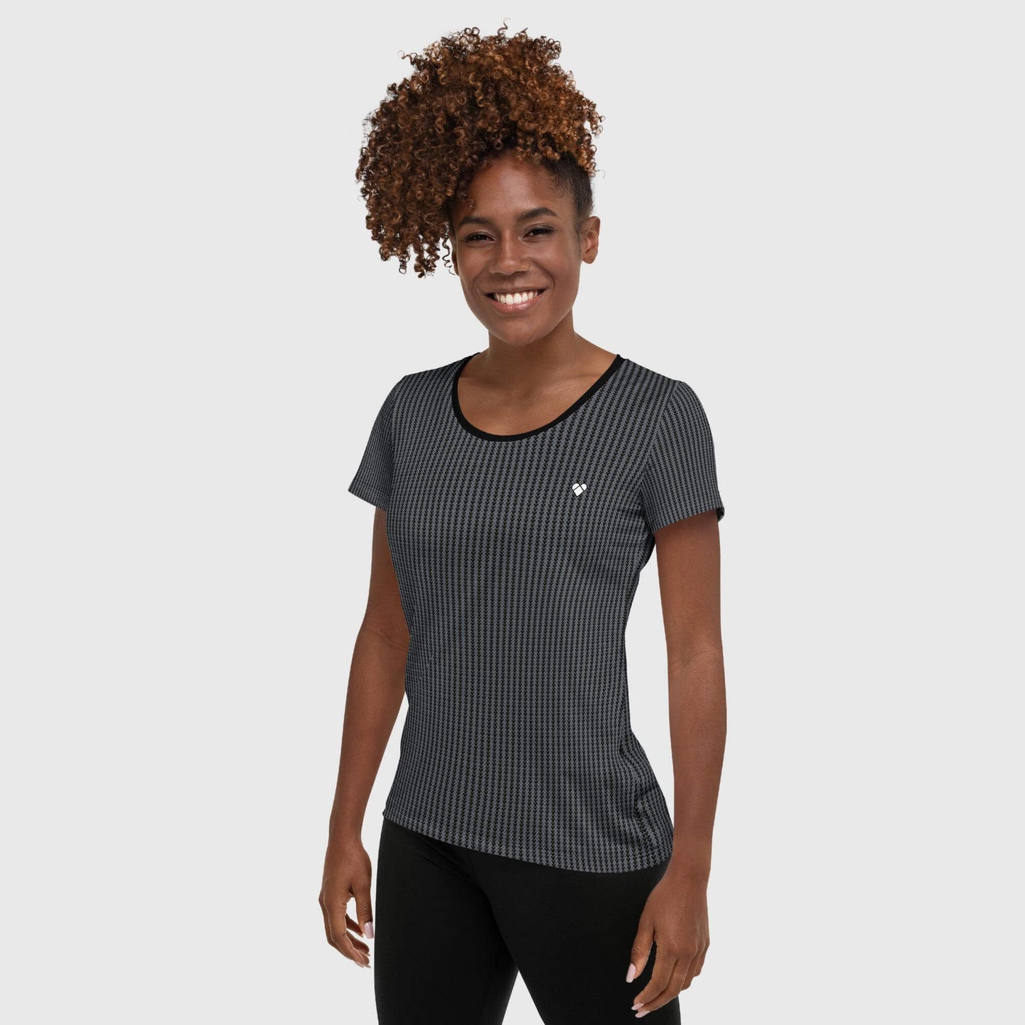 female model wearing Empowering Black Sport Shirt with Geometric Hearts, White Heart Pattern, and Logo Stripe for Gym or Athletic Activities